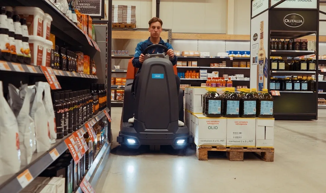 Meijer SR750C driving through a narrow aisle between the shelves
