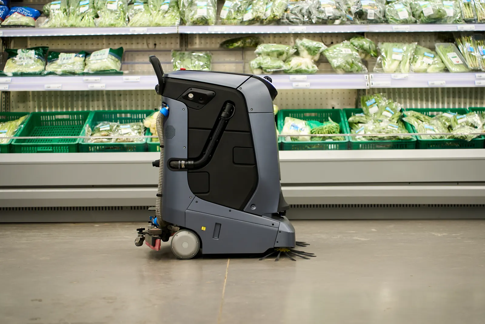 Mira van opzij in een supermarktgang, met zijborstels voorop en zuigrubber erachter